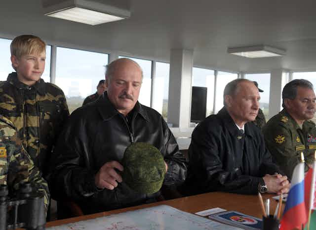 Belarus president Alexander Lukashenko with Vladimir Putin and Russian army officers.