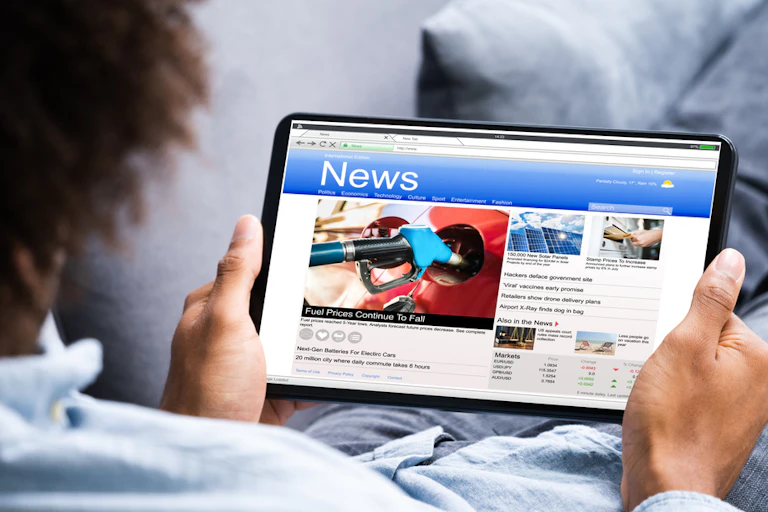A man reading news on his tablet.