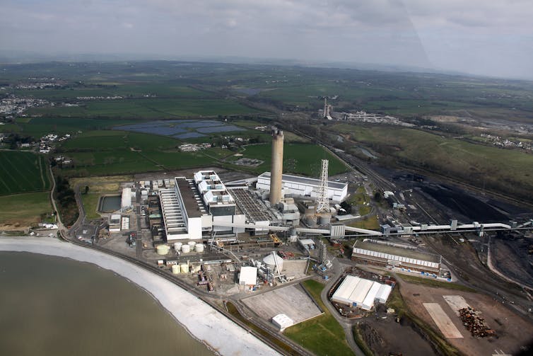 A large industrial site featuring several buildings and chimneys