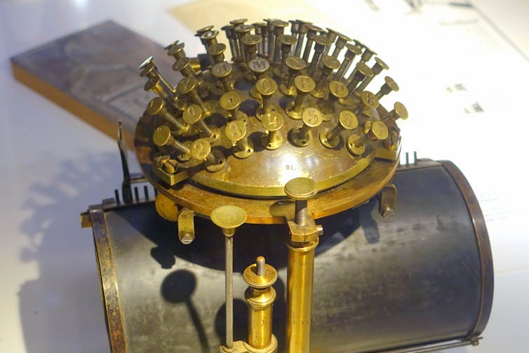 Malling-Hansen writing ball, as used by F. Nietzsche following his loss of eyesight. The keyboard is oval in shape, and the roll that holds the paper is inserted underneath.