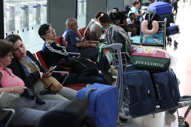 Passengers wait in a departure lounge at Heathrow Airport in London, Britain, 28 August 2023.