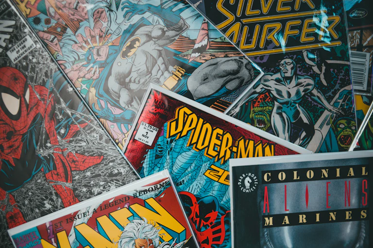 A pile of comic books including Spider-Man and Silver Surfer.