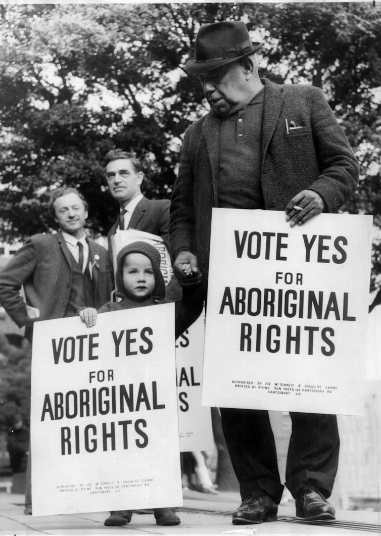 A child and Onus, each holding a sign reading 'Vote Yes for Aboriginal Rights'