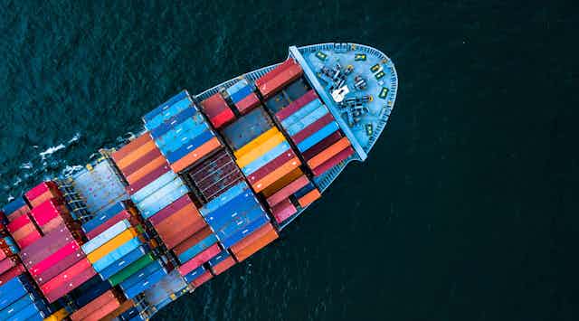Aerial view of a colourful cargo ship in the open sea.