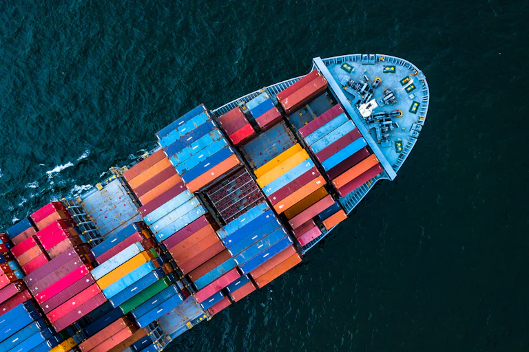 Aerial view of a colourful cargo ship in the open sea.