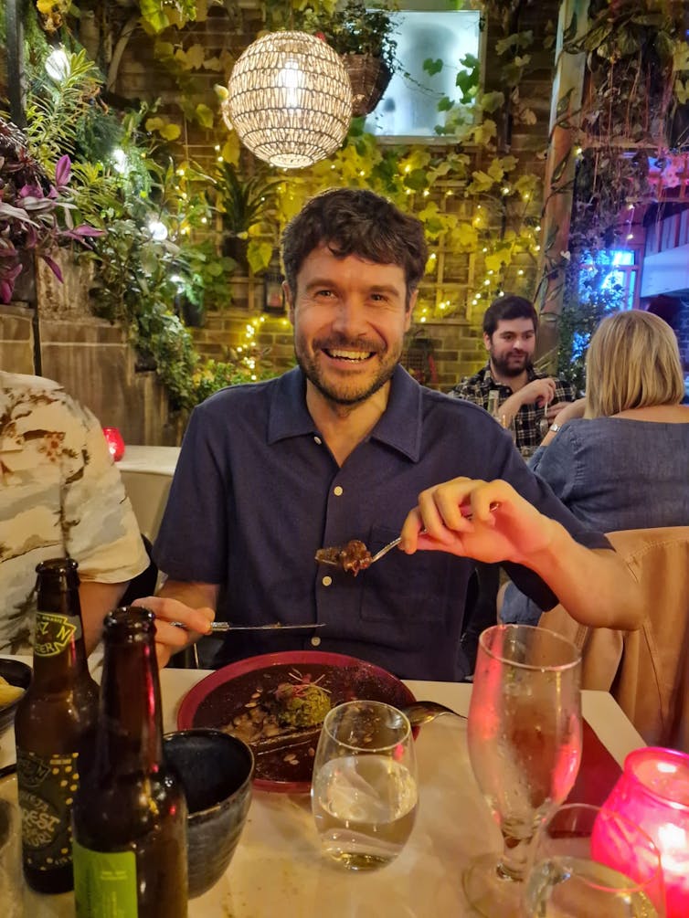 Man in a restaurant eating a meal.