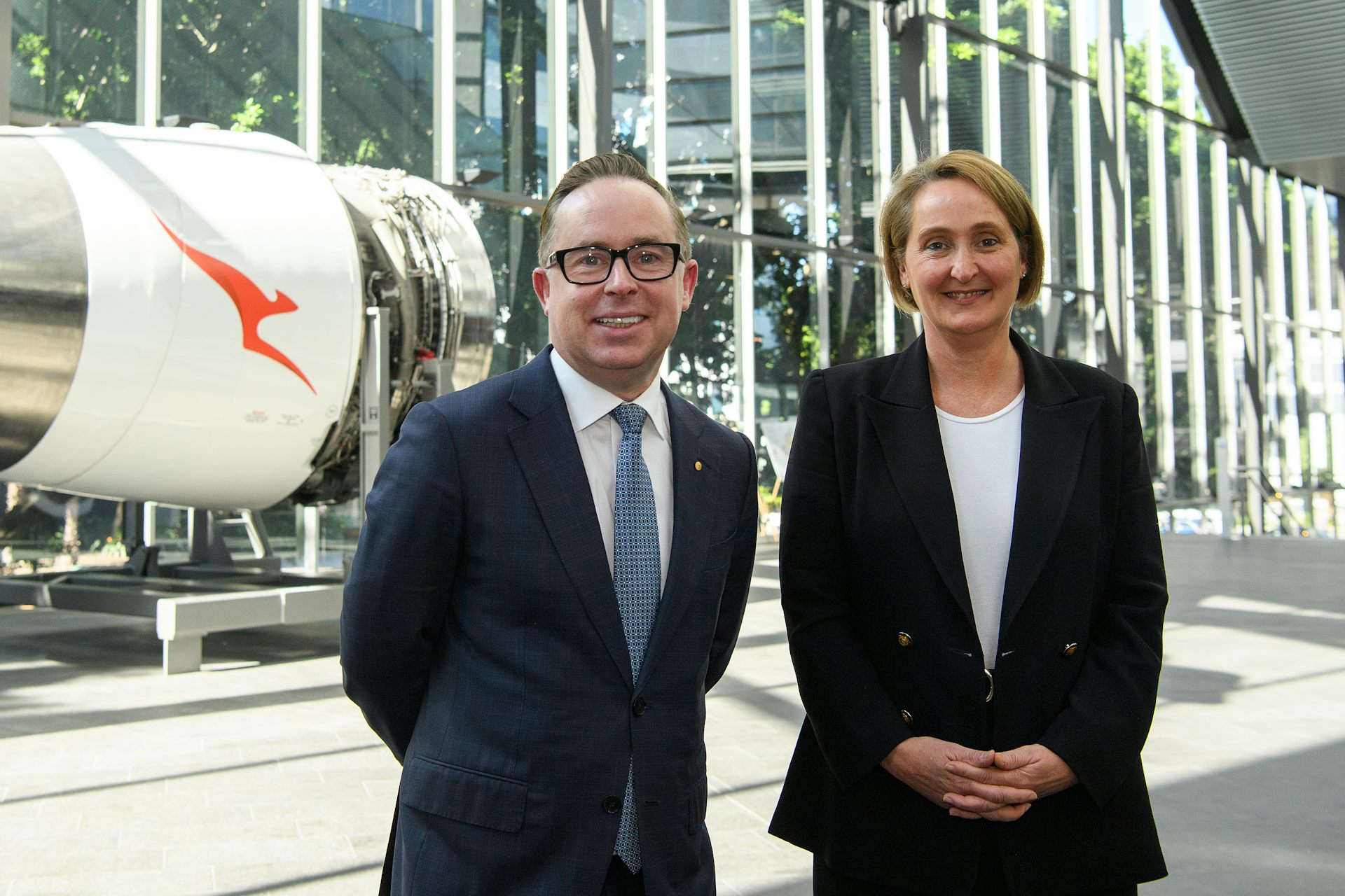 Man and woman standing in front of a plane engine