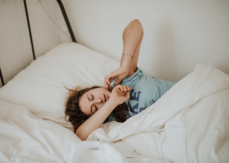 Woman stretches after waking up