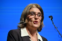 Woman speaking at a microphone