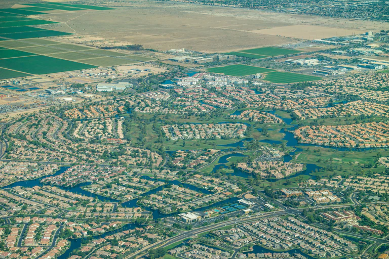 Aerial view of a sprawling suburban community with lush greenery.