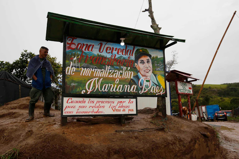 A Farc fighter stands by the entrance to the newly cuilt Mariana Paez demobilisation zone in 2017