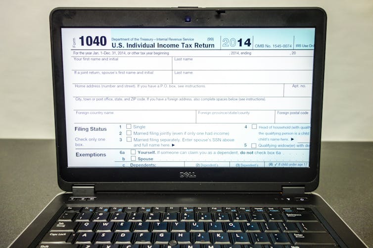 A 2014 1040 U.S. tax form displayed on a laptop
