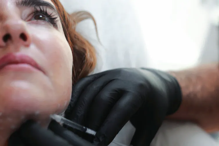 Women getting an injection in face.