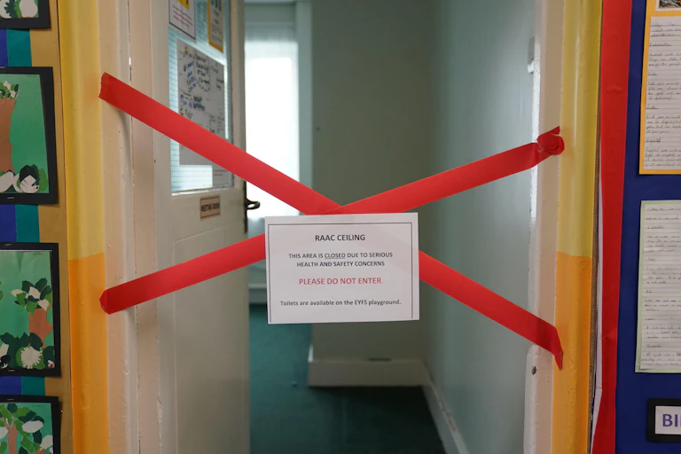 A sign taped across a doorway.