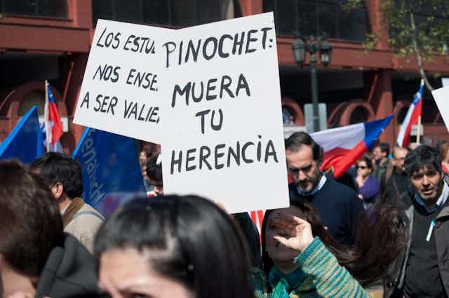 Pancarta en una manifestación que dice "Pinochet: muera tu herencia".