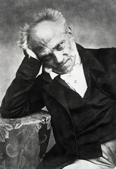 19th-century black-and-white photographic portrait of seated man resting head in hand.