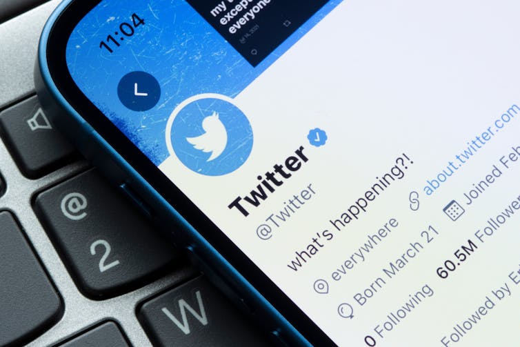 A cell phone displaying the Twitter homepage on the Twitter social media site