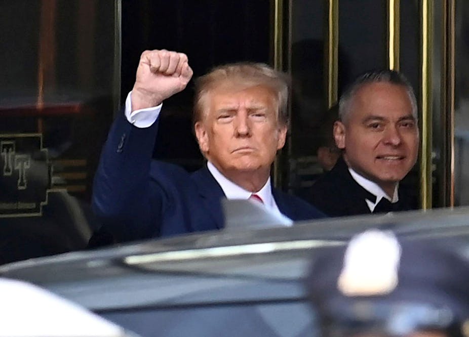 Former US president Donald Trump outside a New York court in September 2023 with his arm raised.