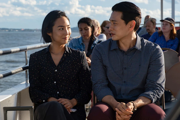 Nora and Hae Sung sit on a ferry.