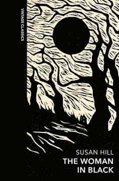 Black and white etching of trees and the moon on the book jacket for The Woman in Black.