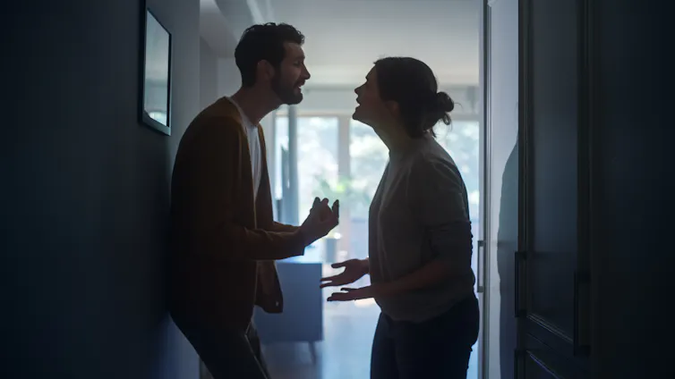 A man and woman in a kitchen arguing.