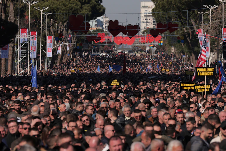 A city street crowded with protesters.