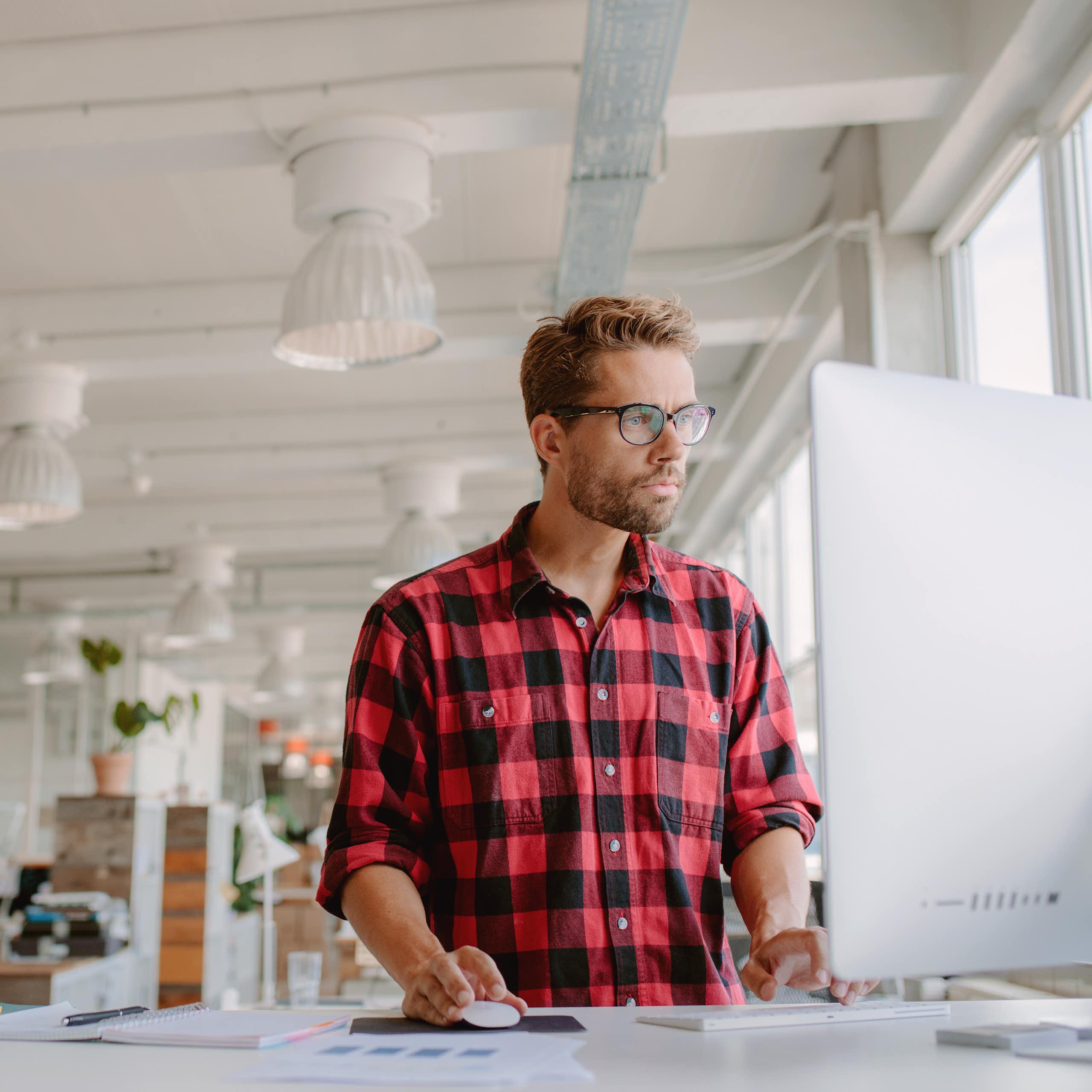 Man works at a standing desk