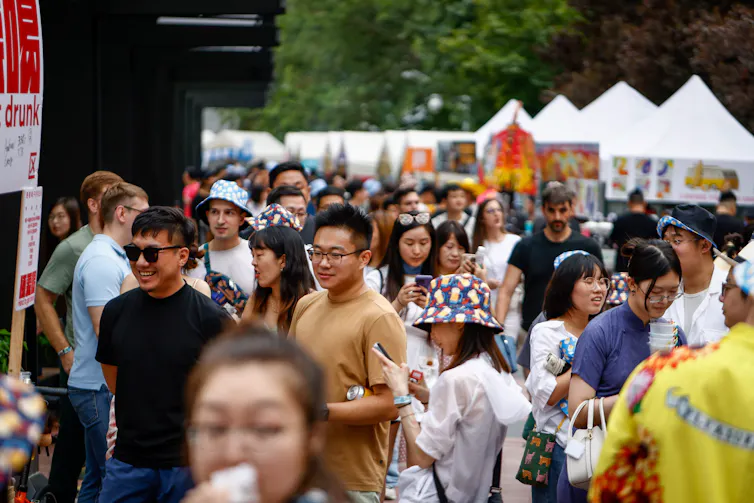 A crowd, many in jeans and t-shirts.