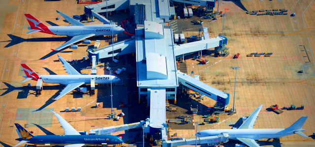 Aerial view of planes docked at a terminal