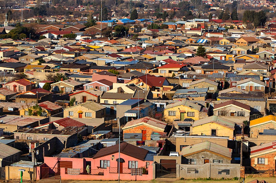 Aerial view of dense settlement of houses of similar design.