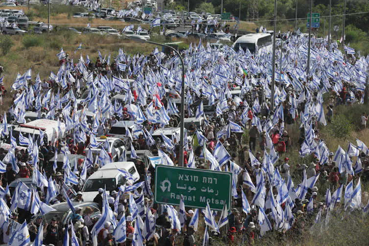 Thousand of Israelis march towards Jerusalem carrying national flags.