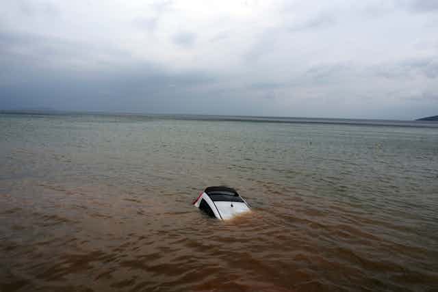 A car washed out to sea by floods in Greece