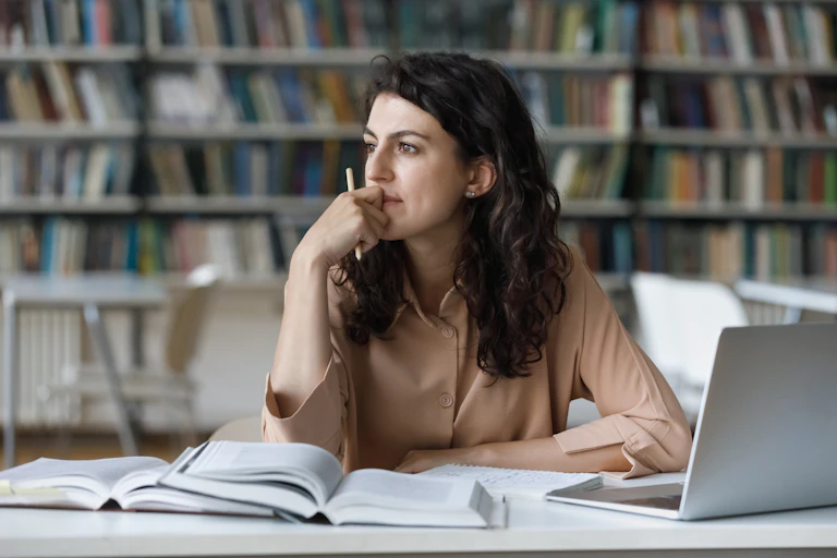 Woman daydreams in a librbary