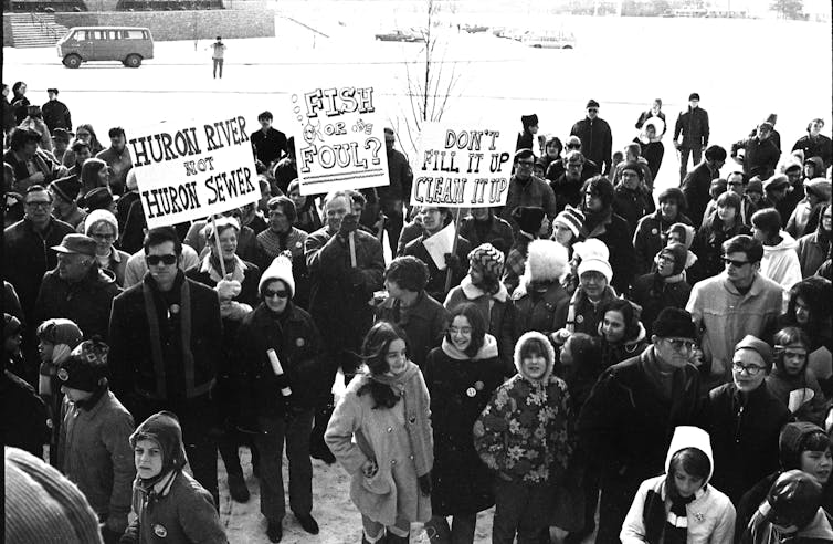A large group of activists - some with signs - protesting pollution of Michigans Huron River on March 14 1970