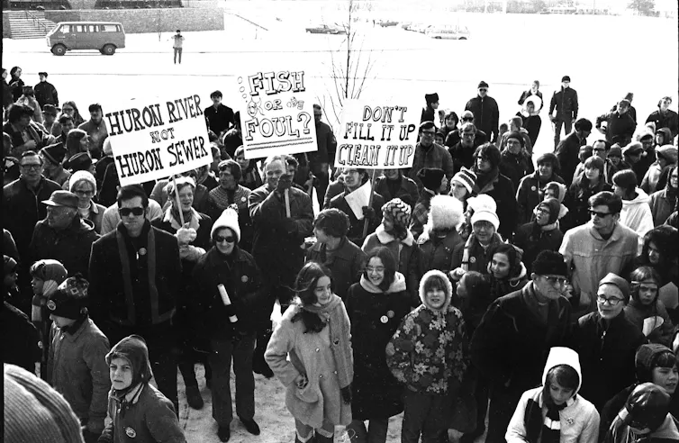 A large group of activists - some with signs - protesting pollution of Michigan's Huron River on March 14, 1970.