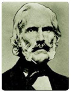 An antique photo of a white-haired man with a white beard.