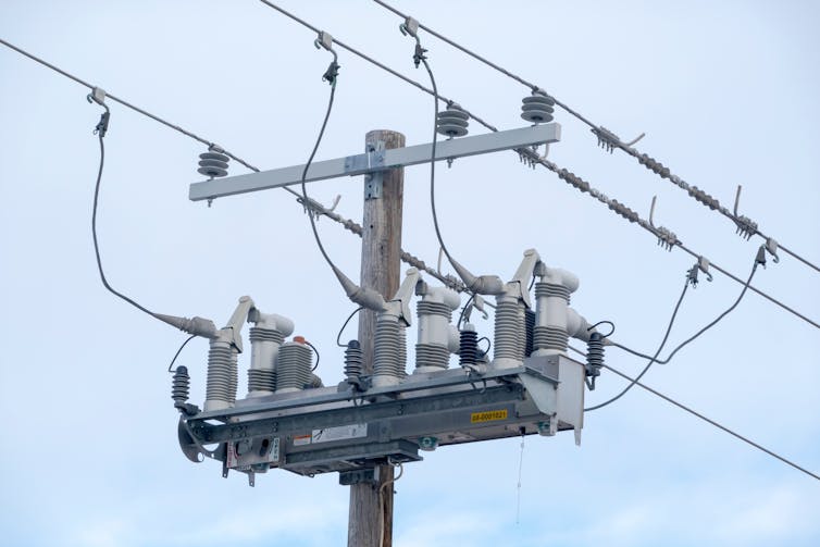 A close-up shot of the top of a power line