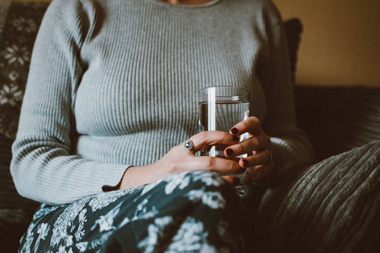 Woman holds drink of water