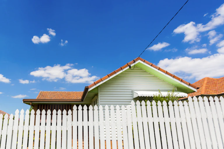 Ordinary house behind a white picket fence