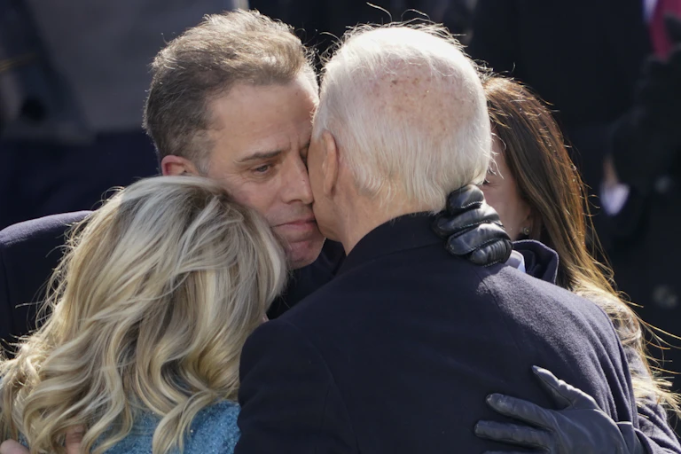 Four people hugging tightly.