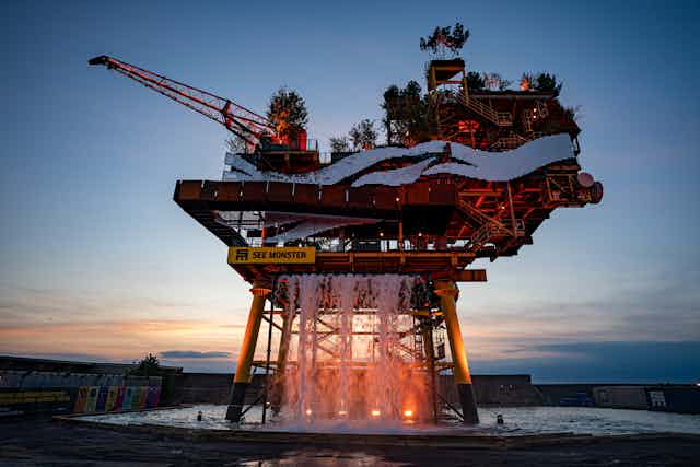 A disused gas platform repurposed as an art installtion, viewed at dusk.
