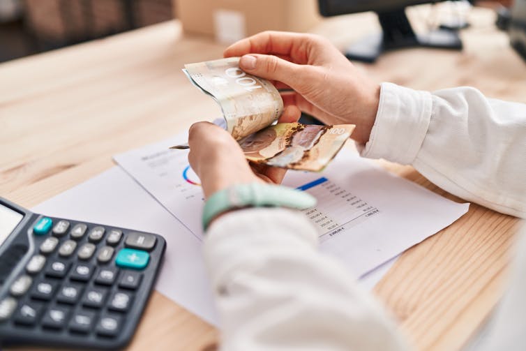 A person counting cash.