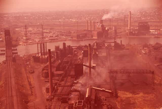 Aerial view of factories emitting smoke.