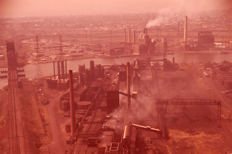 Aerial view of factories emitting smoke.