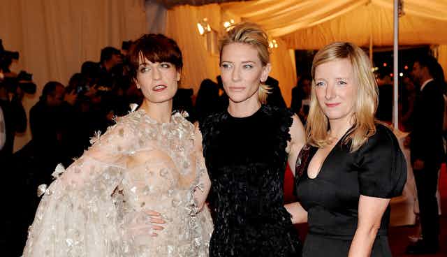 Sarah Burton at a red carpet event with Florence Welch and Cate Blanchett. 