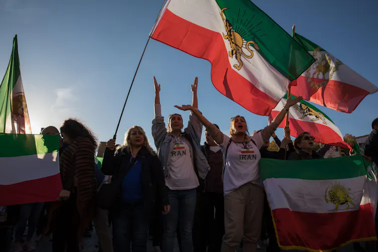 Protesters in Berlin wave flags as the call for change in Iran.