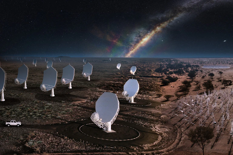 rows of white satellite dishes in the desert