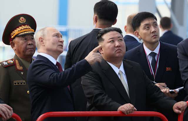 VLadimir Putin points our a feature of Vostochny cosmodrome to North Korean leader Kim Jong-un