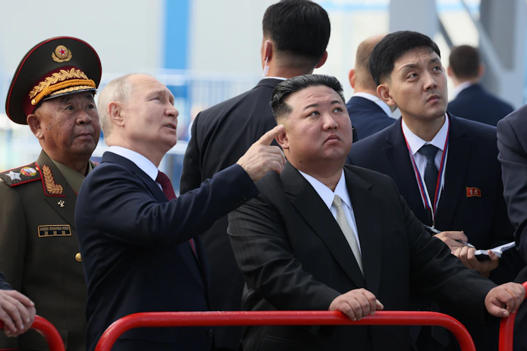 VLadimir Putin points our a feature of Vostochny cosmodrome to North Korean leader Kim Jong-un