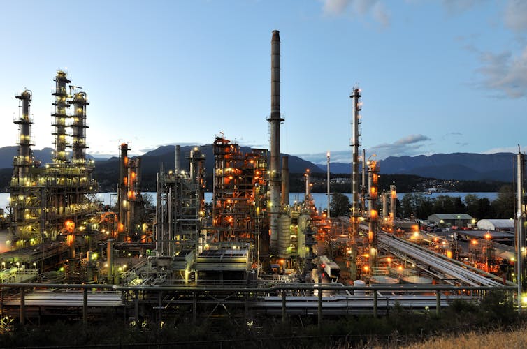 View of an oil refinery, with mountains in the background